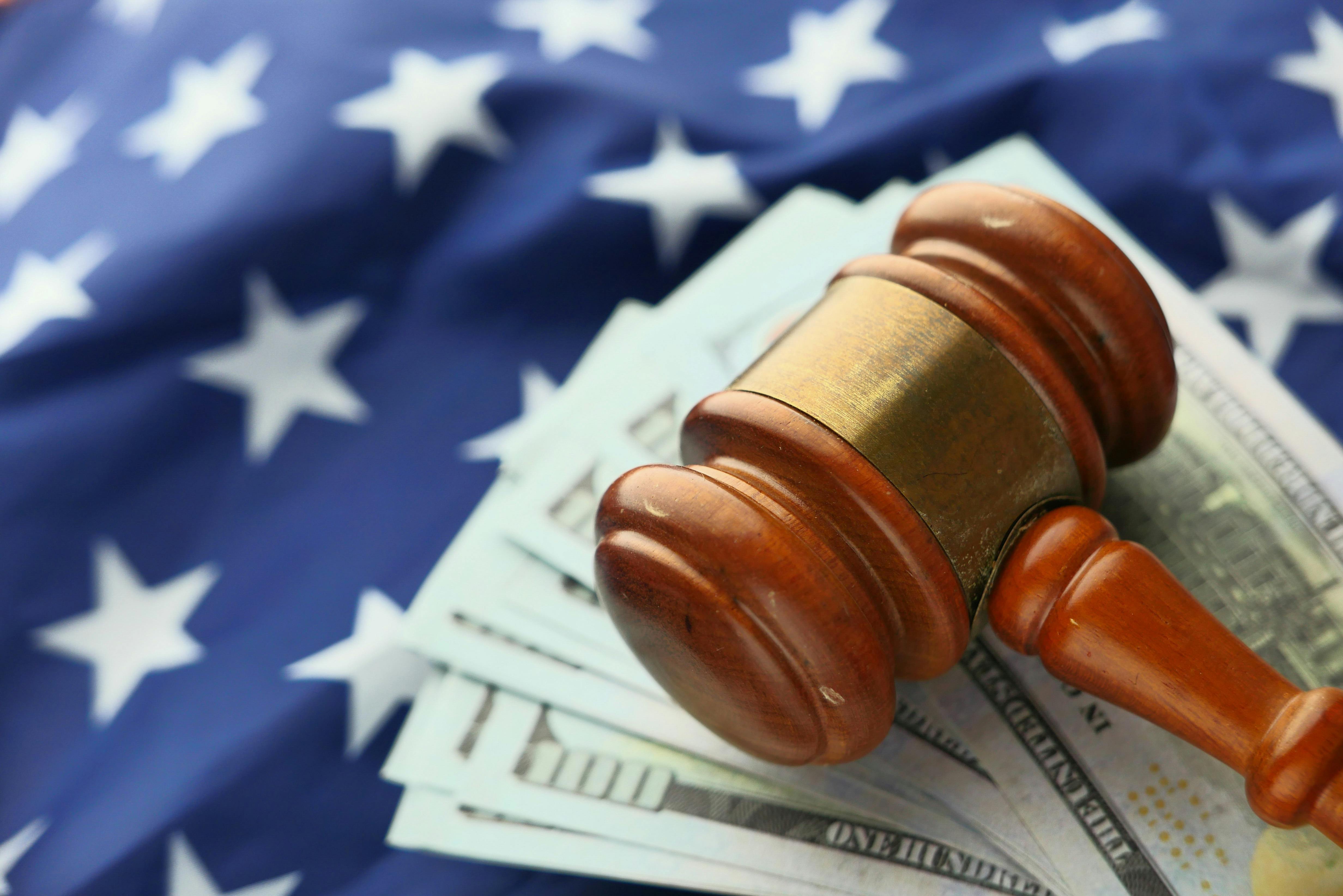 Close-Up photo of Wooden Judge Gavel Over Paper Bills